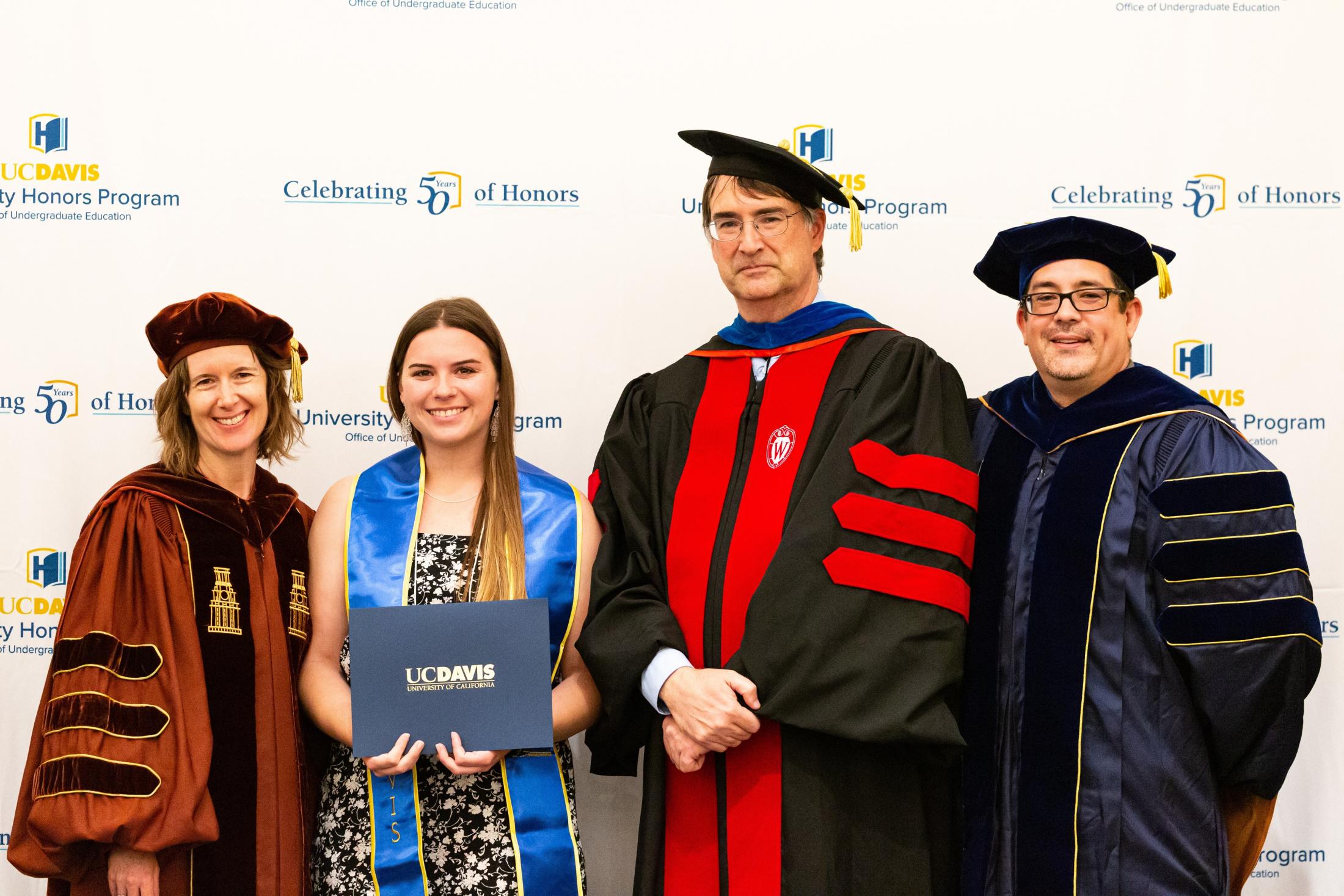 2019 UC Davis University Honors Program graduate Sofia Donovan (second from left) receives her UHP certificate of completion