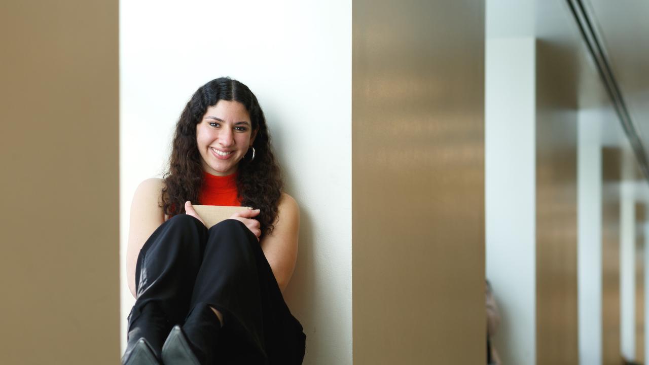 Jumana Esau seated in a window in Shields Library